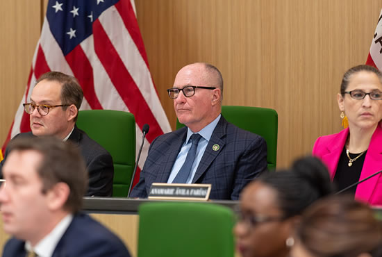 Asm. Hart seated at desk with other committee members