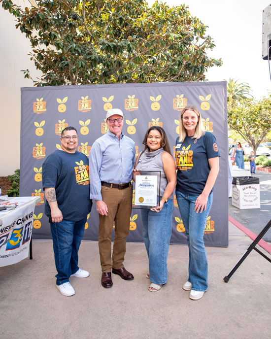 Group photo of Asm. Hart with foodbank staff