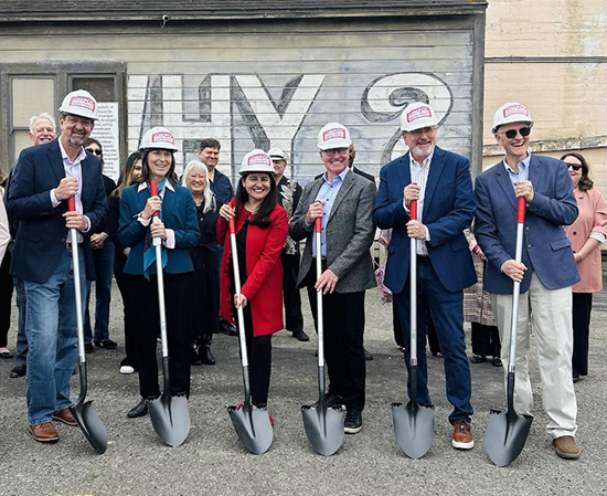 Asm. Hart and others with shovels and wearing hard hats