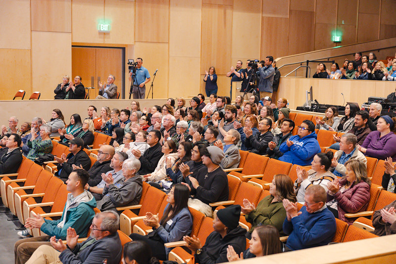 Many audience members clapping