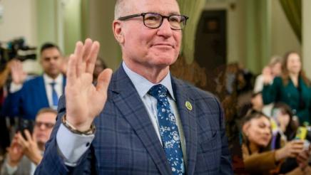 Asm. Hart holding up one hand