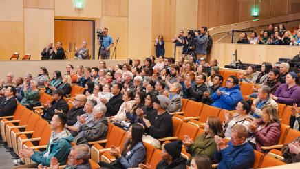 Many audience members clapping